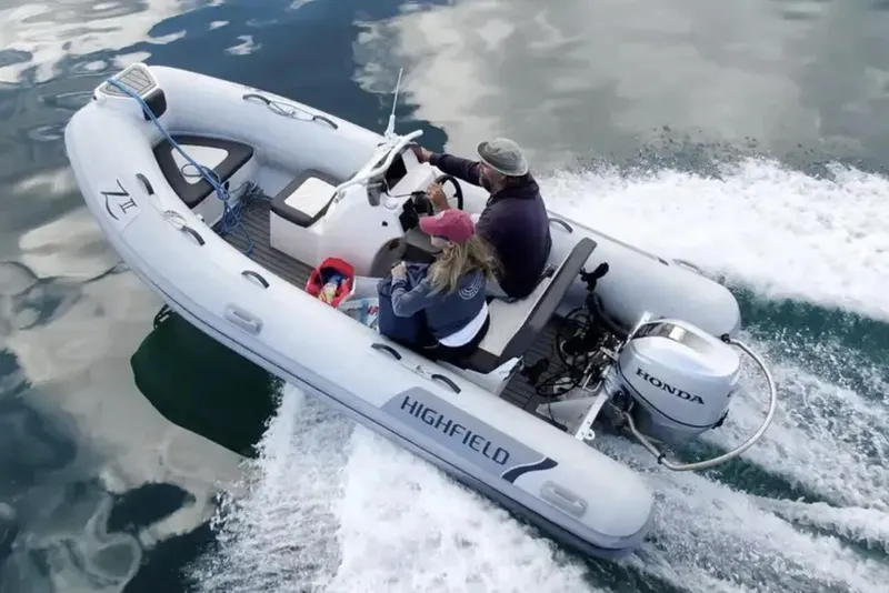 Slide: The Image of Manufacturer Provided Image: 2024 Highfield Classic 420 inflatable boat on water with Honda outboard motor. - 11