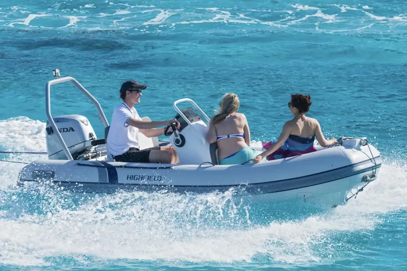 Slide: The Image of Manufacturer Provided Image: 2024 Highfield Classic 420 boat cruising with three people on clear blue water. - 12