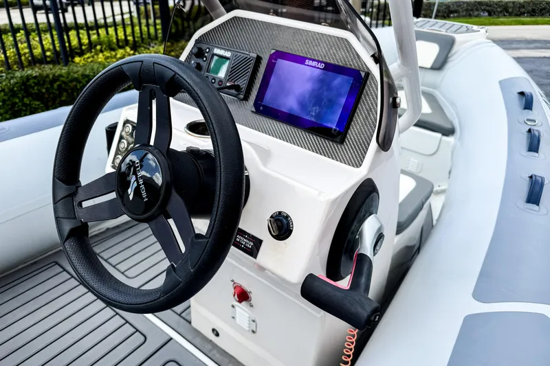 Slide: The Image of 2024 Highfield Classic 420 boat dashboard with steering wheel and navigation display. - 4