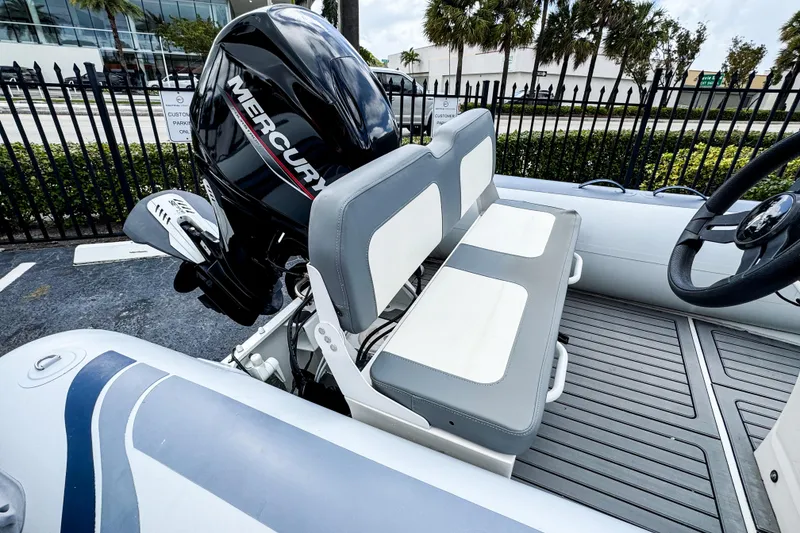 Slide: The Image of 2024 Highfield Classic 420 boat with Mercury engine, featuring dual seating and steering wheel. - 7