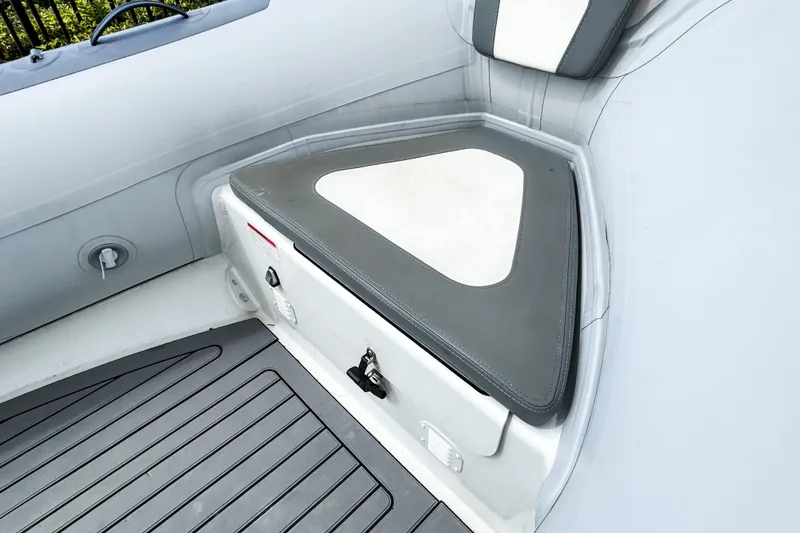 Slide: The Image of 2024 Highfield Classic 420 boat interior with cushioned seating and storage compartment. - 8