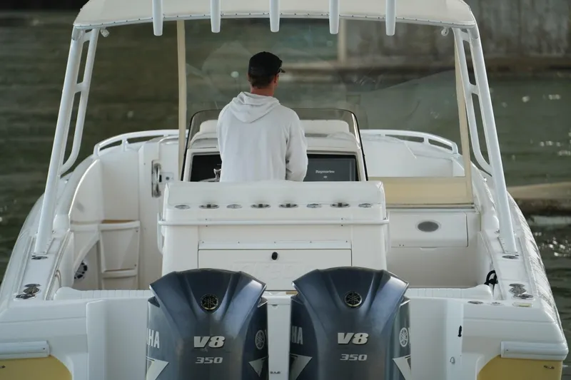 Slide: The Image of 2003 Intrepid 370 Cuddy boat with dual Yamaha V8 engines on water. - 11