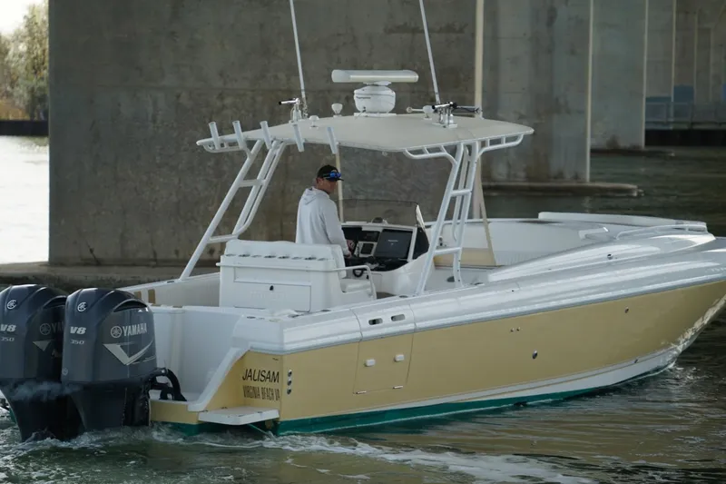 Slide: The Image of 2003 Intrepid 370 Cuddy boat with dual Yamaha V8 engines under a bridge. - 12