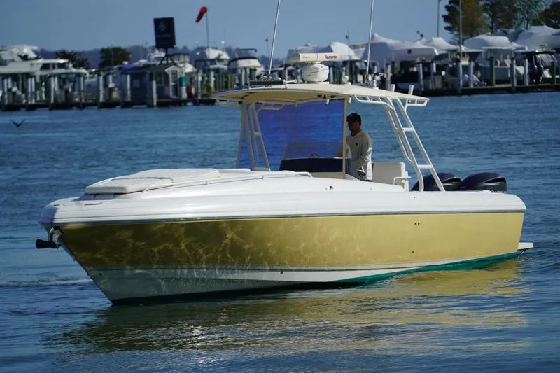 Slide: The Image of 2003 Intrepid 370 Cuddy boat cruising near a marina. - 2