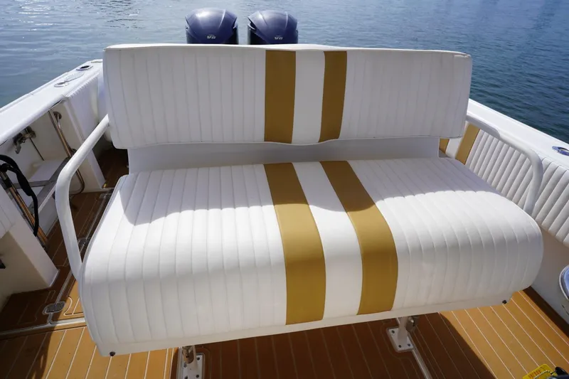 Slide: The Image of White and gold seating on a 2003 Intrepid 370 Cuddy boat deck. - 27