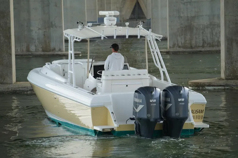 Slide: The Image of 2003 Intrepid 370 Cuddy boat with dual Yamaha V8 engines navigating under a bridge. - 3