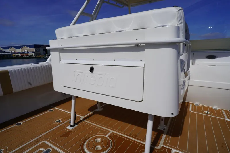 Slide: The Image of 2003 Intrepid 370 Cuddy boat interior with white seating and teak flooring. - 30