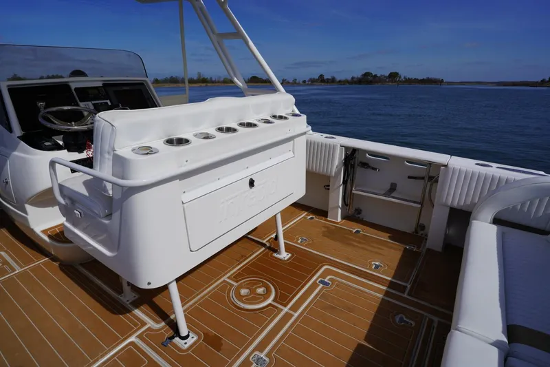 Slide: The Image of 2003 Intrepid 370 Cuddy boat interior with helm, seating, and ocean view. - 31