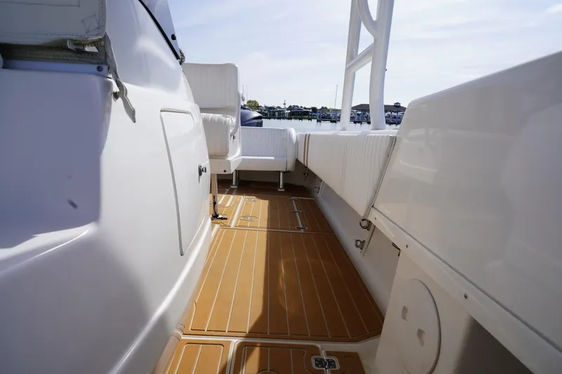 Slide: The Image of 2003 Intrepid 370 Cuddy boat interior with teak flooring and white seating. - 35