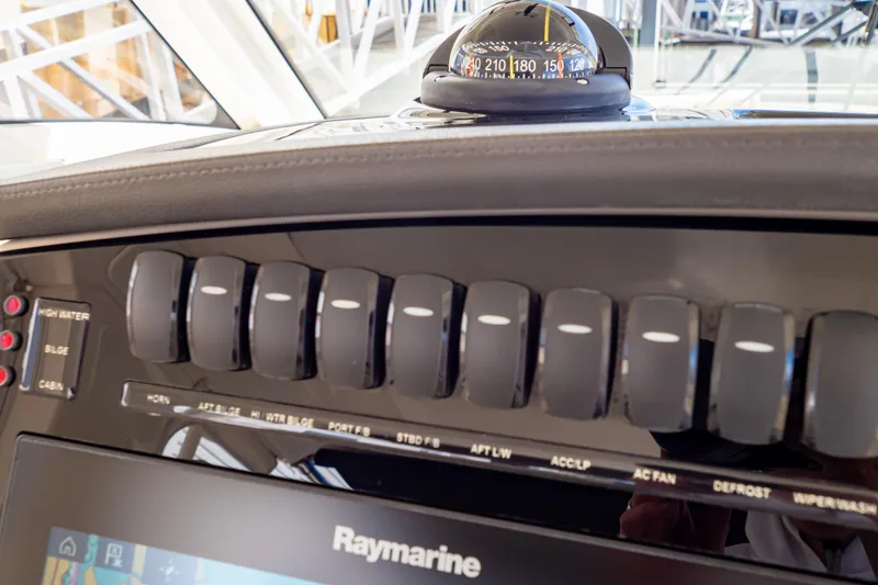 Slide: The Image of Control panel of 2019 Boston Whaler 350 Realm with compass and Raymarine display. - 100