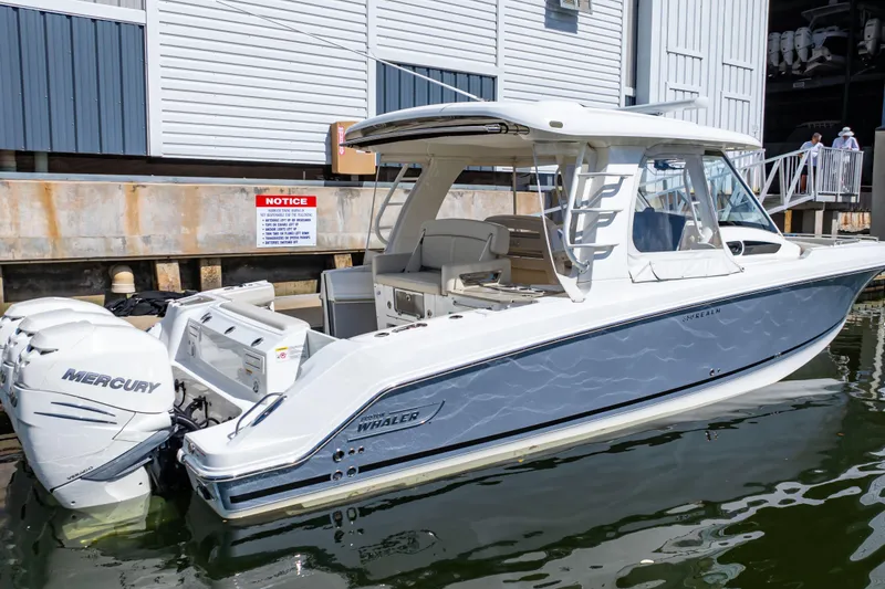 Slide: The Image of 2019 Boston Whaler 350 Realm boat docked with Mercury engines. - 102
