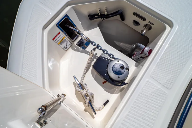 Slide: The Image of Anchor compartment of 2019 Boston Whaler 350 Realm boat with chain and rope. - 106