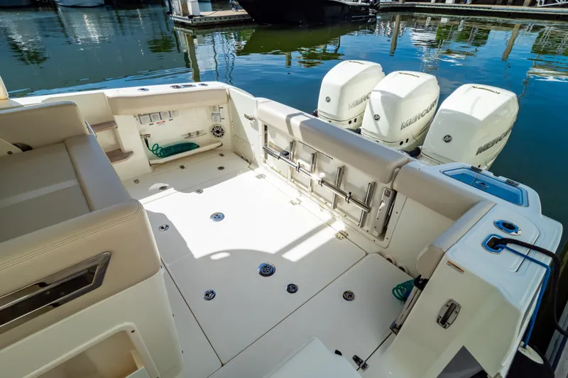 Slide: The Image of 2019 Boston Whaler 350 Realm boat interior with triple Mercury engines at dock. - 108