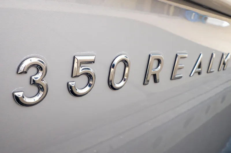 Slide: The Image of Close-up of 2019 Boston Whaler 350 Realm chrome lettering on boat hull. - 110