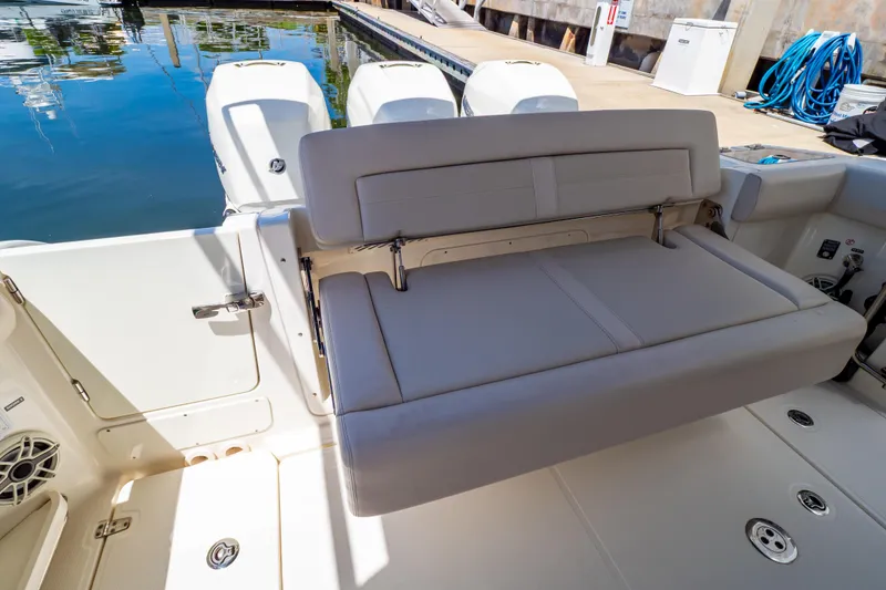 Slide: The Image of 2019 Boston Whaler 350 Realm boat with foldable seating and triple outboard engines. - 2