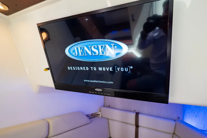 Slide: The Image of Jensen TV inside 2019 Boston Whaler 350 Realm boat cabin, showcasing modern entertainment features. - 25