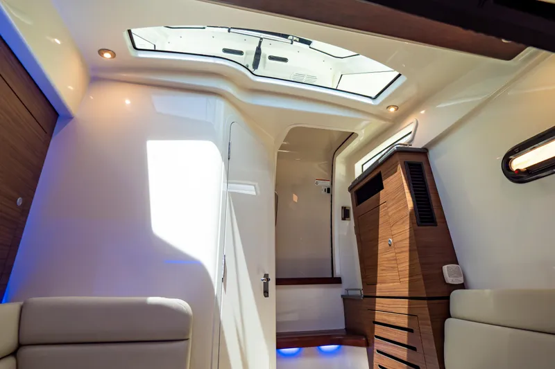Slide: The Image of Interior of 2019 Boston Whaler 350 Realm, featuring modern design and ambient lighting. - 28