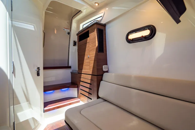 Slide: The Image of Luxurious interior of 2019 Boston Whaler 350 Realm with seating and wooden cabinetry. - 29