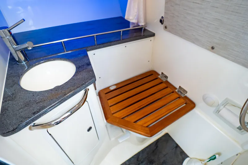 Slide: The Image of Luxurious bathroom interior of 2019 Boston Whaler 350 Realm boat with wooden seat. - 35