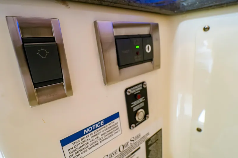 Slide: The Image of Control panel on a 2019 Boston Whaler 350 Realm boat, featuring switches and notices. - 36