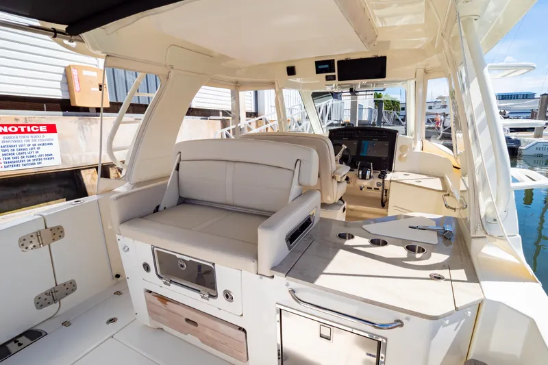 Slide: The Image of 2019 Boston Whaler 350 Realm boat interior with seating and control panel. - 4