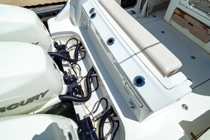Slide: The Image of 2019 Boston Whaler 350 Realm boat with Mercury engines and cushioned seating area. - 48