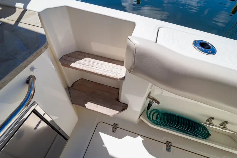 Slide: The Image of 2019 Boston Whaler 350 Realm boat interior with steps and storage compartment. - 52