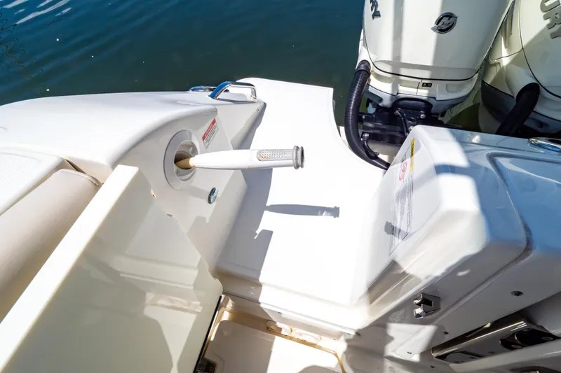 Slide: The Image of 2019 Boston Whaler 350 Realm boat deck with engine and water hose detail. - 56