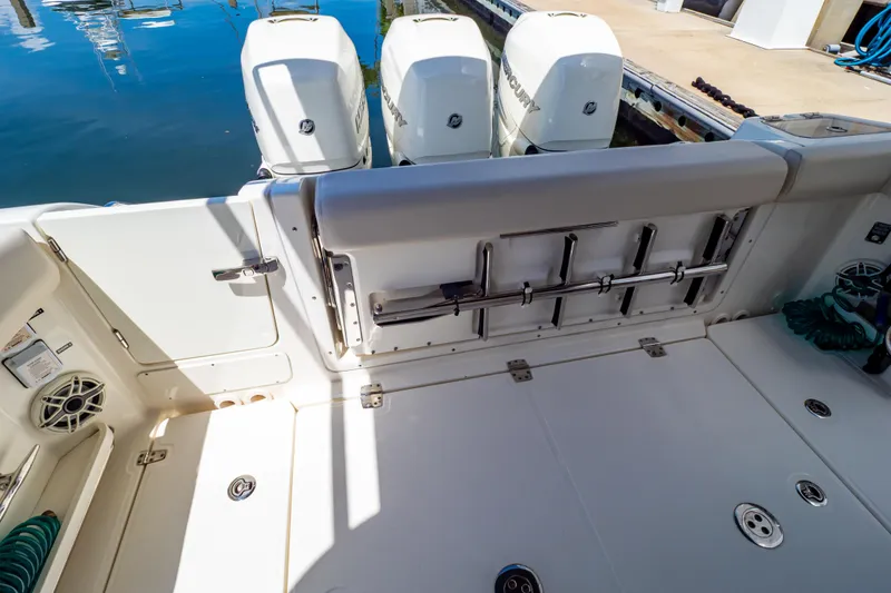 Slide: The Image of 2019 Boston Whaler 350 Realm boat deck with triple Mercury outboard engines. - 57
