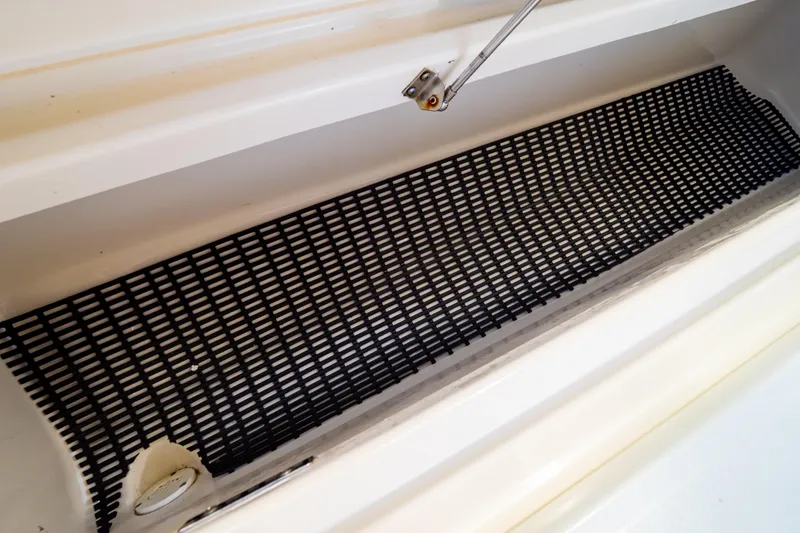 Slide: The Image of Storage compartment with black mat in 2019 Boston Whaler 350 Realm boat. - 62
