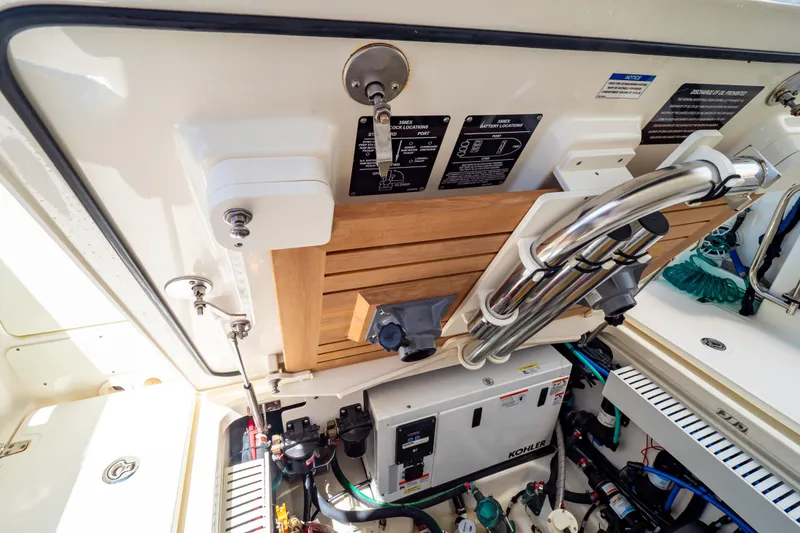 Slide: The Image of Engine compartment of a 2019 Boston Whaler 350 Realm with Kohler generator. - 63