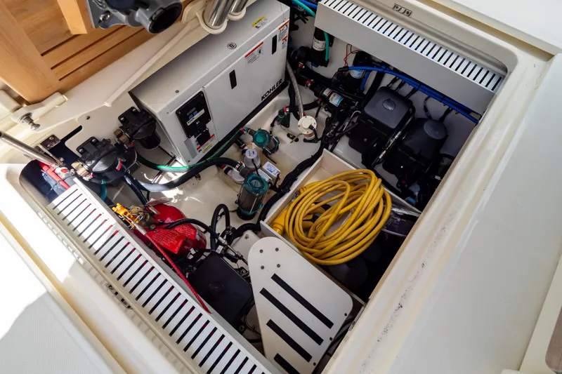 Slide: The Image of Engine compartment of 2019 Boston Whaler 350 Realm with equipment and wiring. - 64