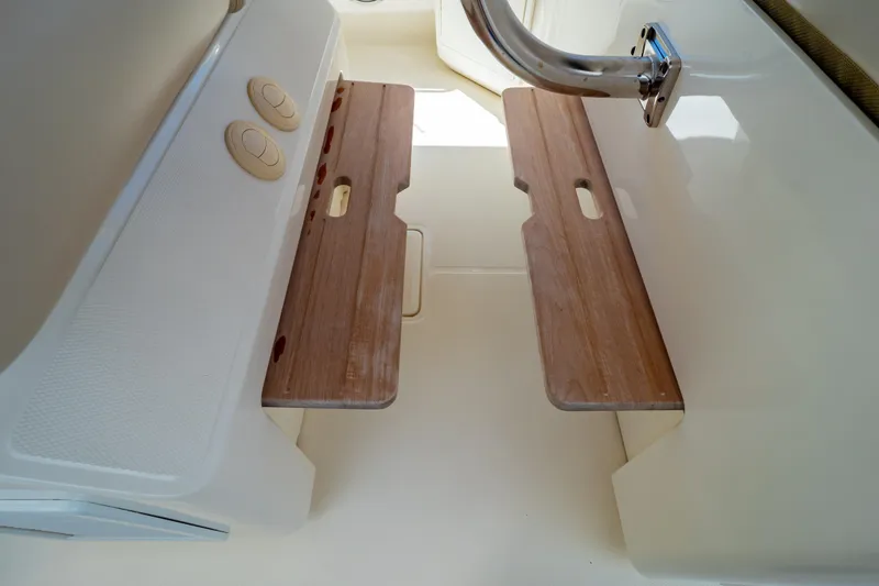 Slide: The Image of Interior view of 2019 Boston Whaler 350 Realm with wooden seating and stainless steel handle. - 69