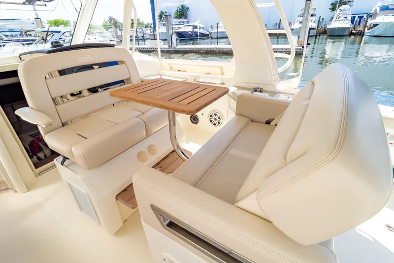 Slide: The Image of Luxurious seating area on 2019 Boston Whaler 350 Realm boat with wooden table. - 70