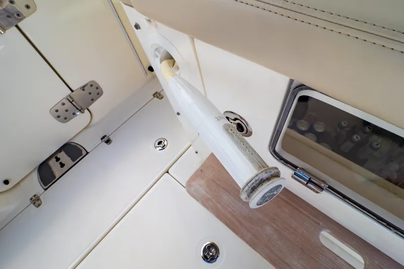 Slide: The Image of 2019 Boston Whaler 350 Realm interior detail with rod holder and storage compartment. - 76