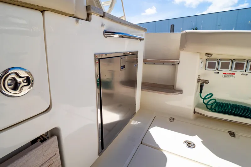 Slide: The Image of 2019 Boston Whaler 350 Realm boat interior with stainless steel features and storage compartments. - 80
