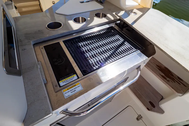 Slide: The Image of Outdoor grill on 2019 Boston Whaler 350 Realm boat, featuring stainless steel design. - 82