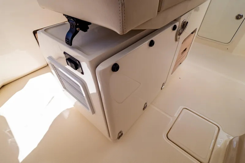 Slide: The Image of Interior view of a 2019 Boston Whaler 350 Realm boat, showcasing storage compartments. - 86