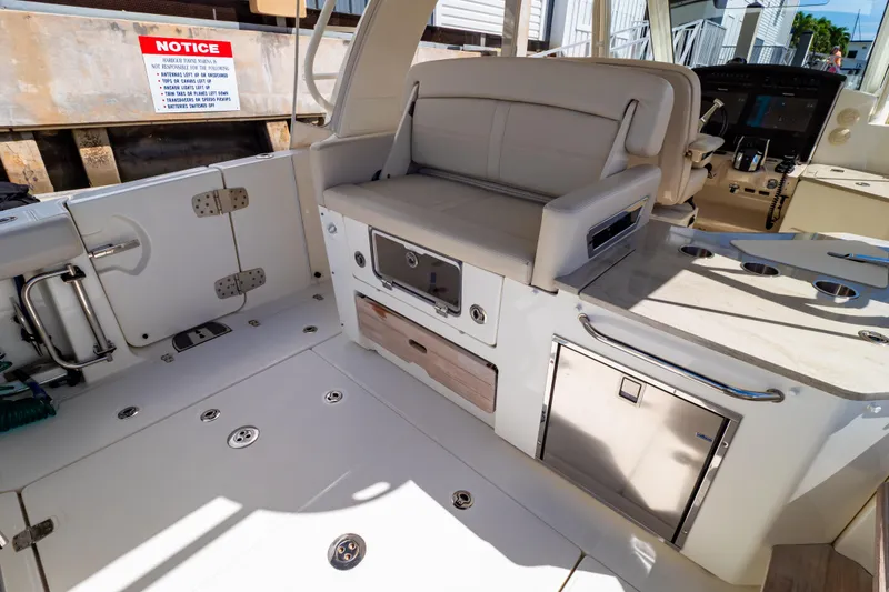 Slide: The Image of 2019 Boston Whaler 350 Realm interior with seating and storage features. - 98