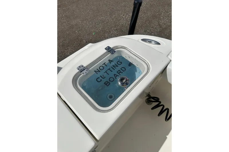 Slide: The Image of 2022 Cobia 220 Center Console boat with "Not a Cutting Board" label on hatch. - 10
