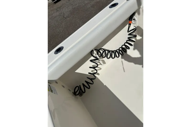 Slide: The Image of 2022 Cobia 220 Center Console boat interior with coiled cable detail. - 11