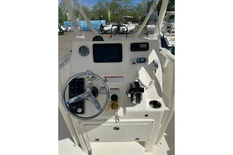 Slide: The Image of 2022 Cobia 220 Center Console boat dashboard with steering wheel and controls. - 12