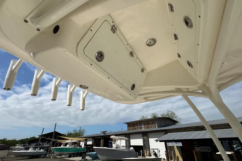 Slide: The Image of 2022 Cobia 220 Center Console boat with rod holders and storage compartments. - 14