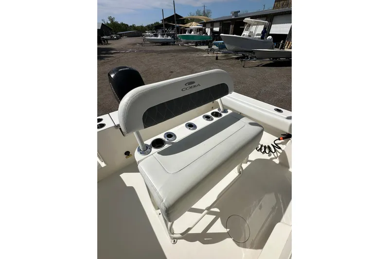 Slide: The Image of 2022 Cobia 220 Center Console boat interior with seating and cup holders. - 16