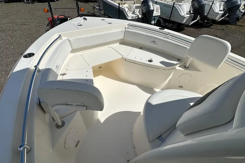 Slide: The Image of 2022 Cobia 220 Center Console boat interior with seating and storage compartments. - 18
