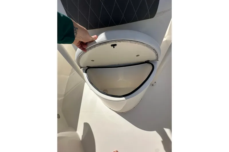 Slide: The Image of Open storage compartment on a 2022 Cobia 220 Center Console boat. - 21
