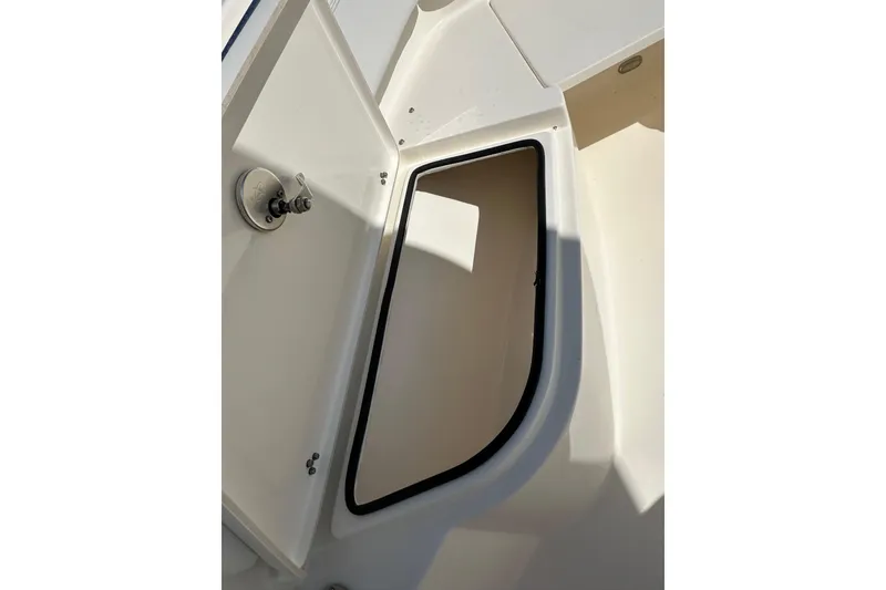 Slide: The Image of 2022 Cobia 220 Center Console boat storage compartment detail. - 23