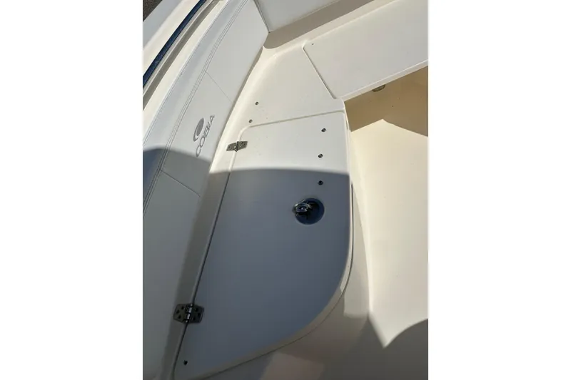 Slide: The Image of 2022 Cobia 220 Center Console boat interior detail with storage compartment. - 24