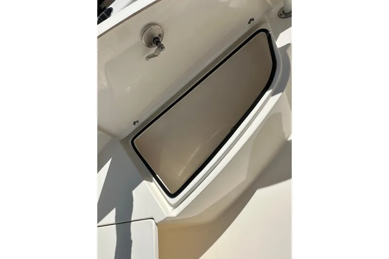 Slide: The Image of 2022 Cobia 220 Center Console boat storage compartment detail. - 25