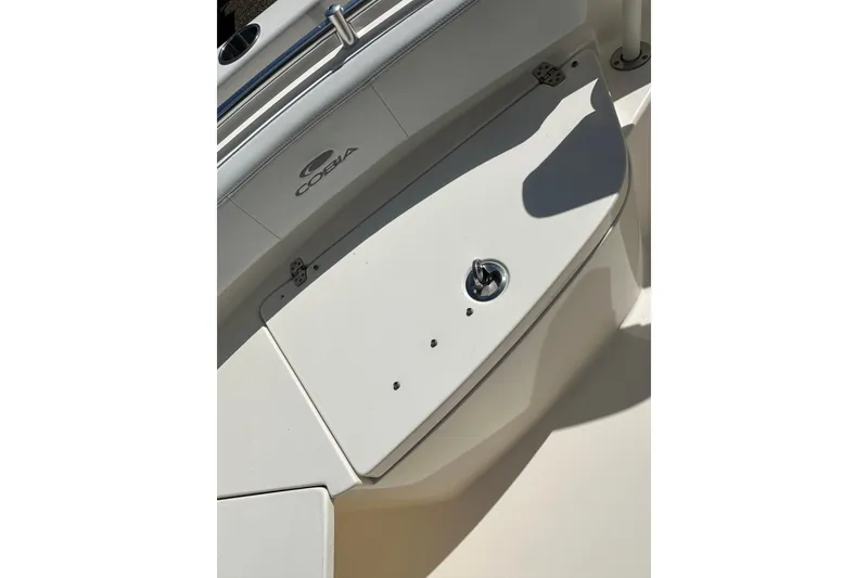 Slide: The Image of 2022 Cobia 220 Center Console boat deck with storage compartment. - 26